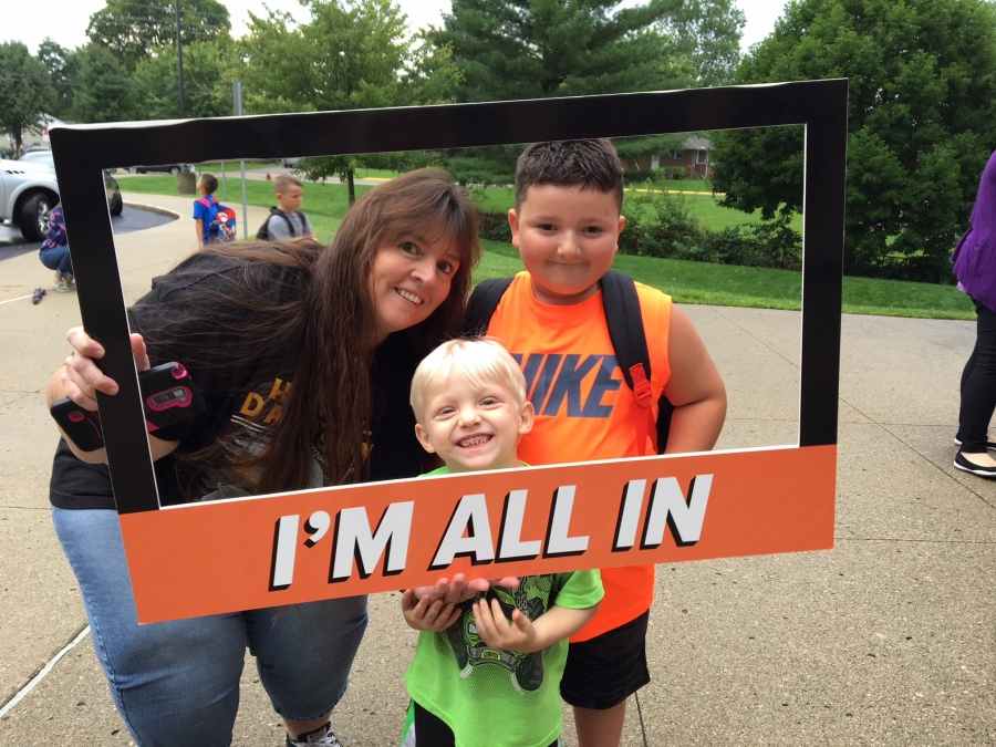 people holding a frame sign